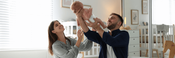 Mother and father playing with their baby