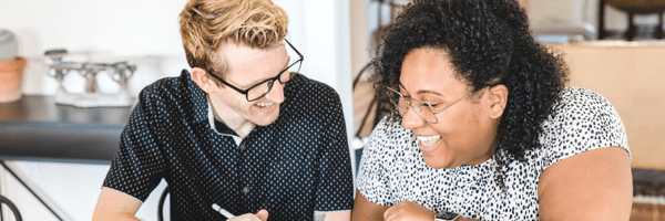Couple discussing money and smiling