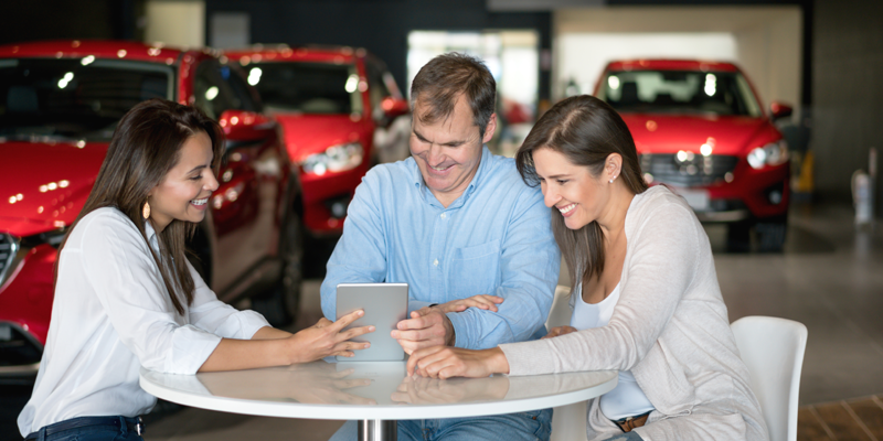 Couple Negotiating at Dealership