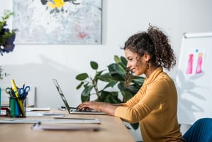 Woman on laptop smiling