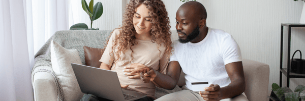 Couple shopping online and holding a credit card