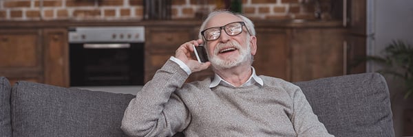 Man talking on the phone happy he knows how to avoid scams!