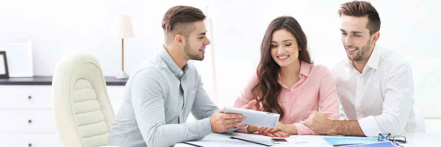 Couple looking over health insurance papers with agent