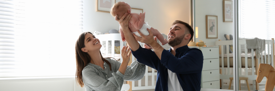 Mother and father playing with their baby