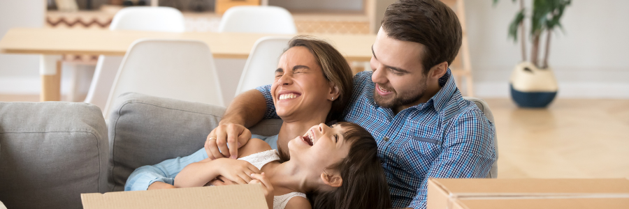 Father, mother, and daughter laughing