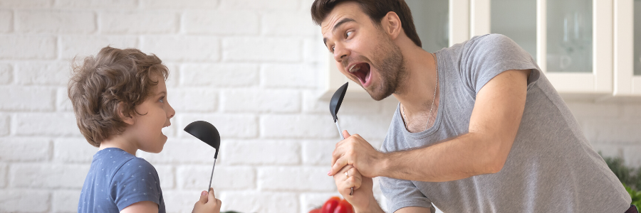 Father and son singing in kitchen