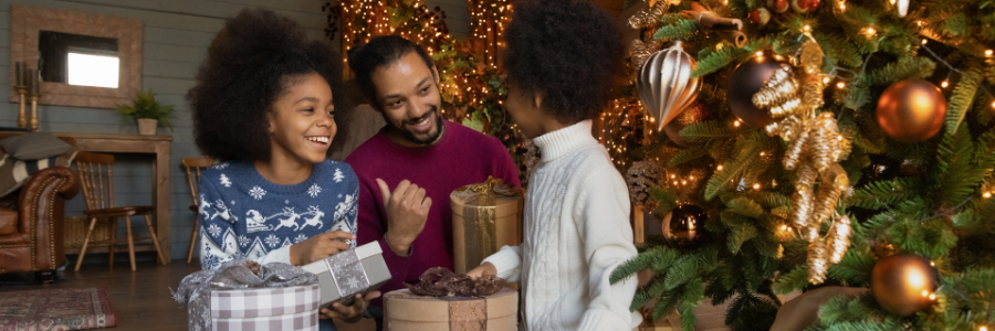 Father and kids in front of Christmas tree