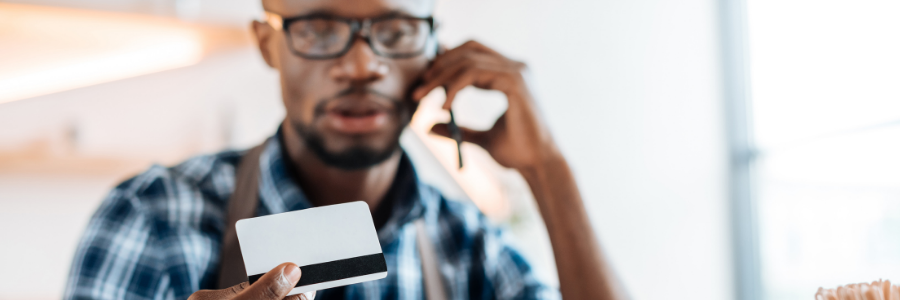 Man on phone holding credit card