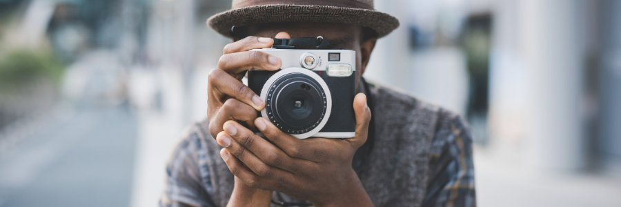 Man using a nice camera to take a photo of you!