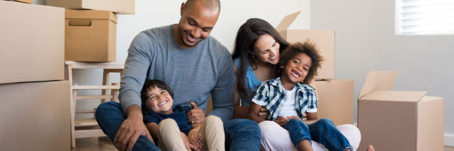 Family happy unpacking boxes in new home.